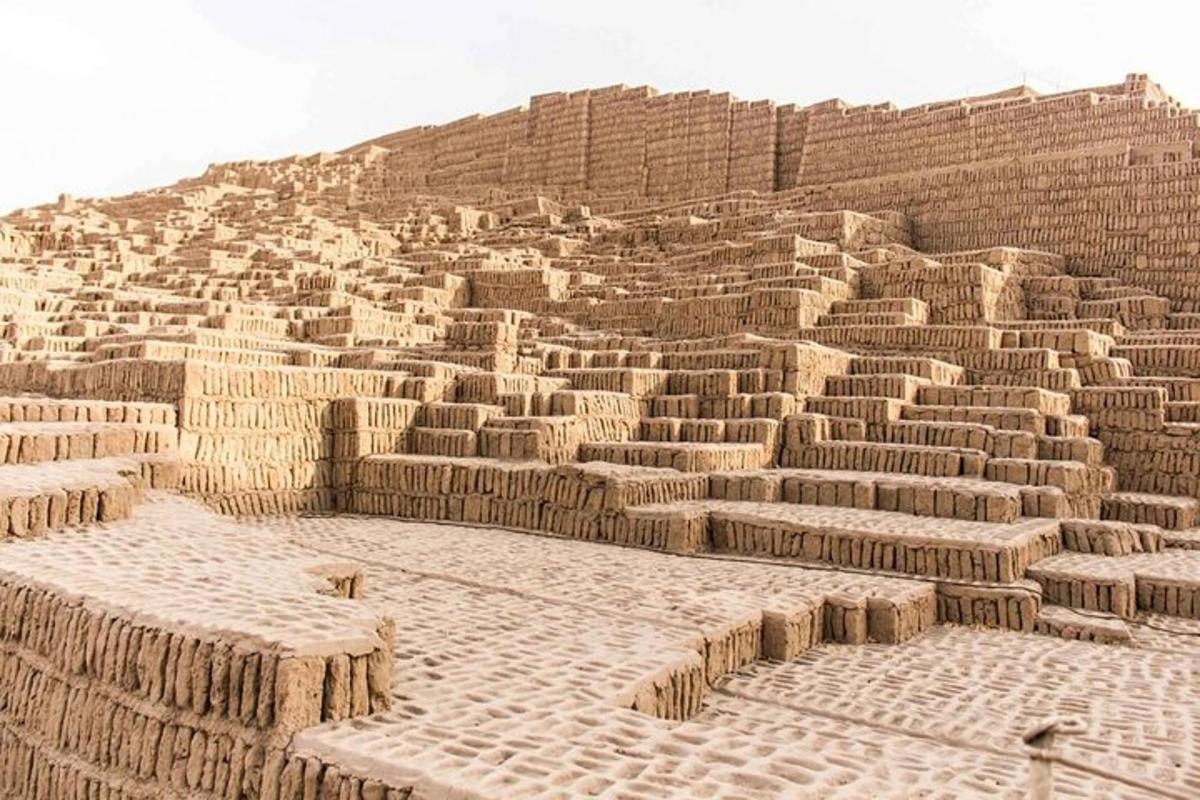 a large brick amphitheater in front of a hill