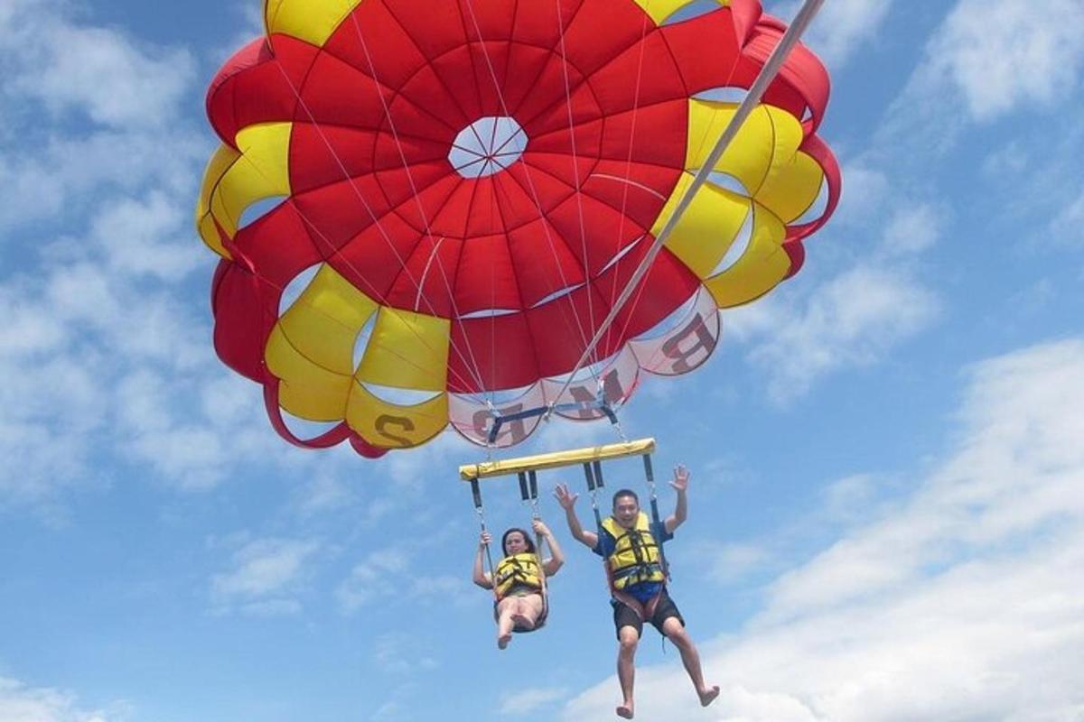 two people are riding on a large parachute