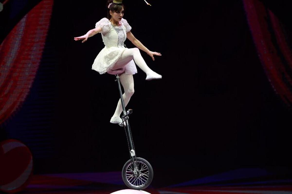 a woman in a dress is riding a scooter