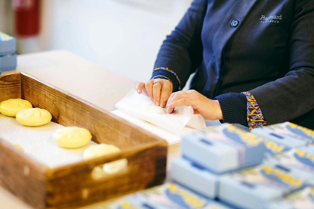 a woman is putting food in a box