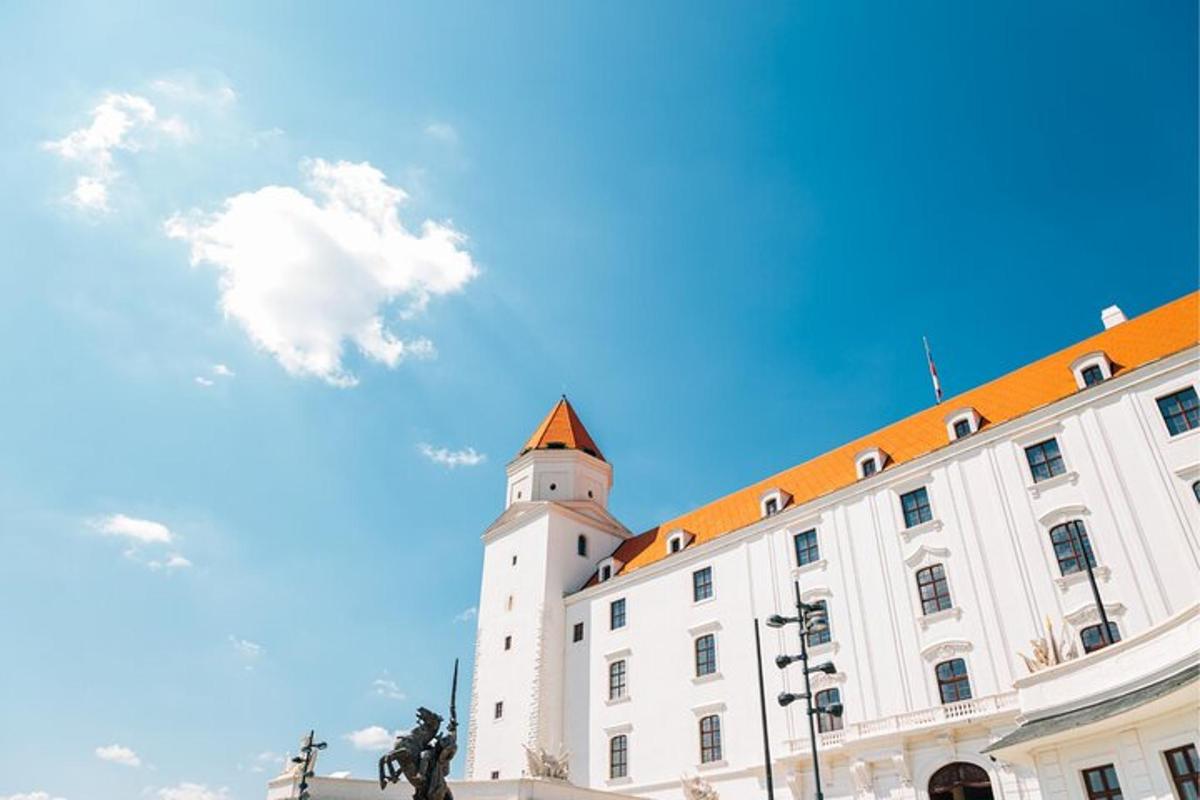 a large white building with an orange roof