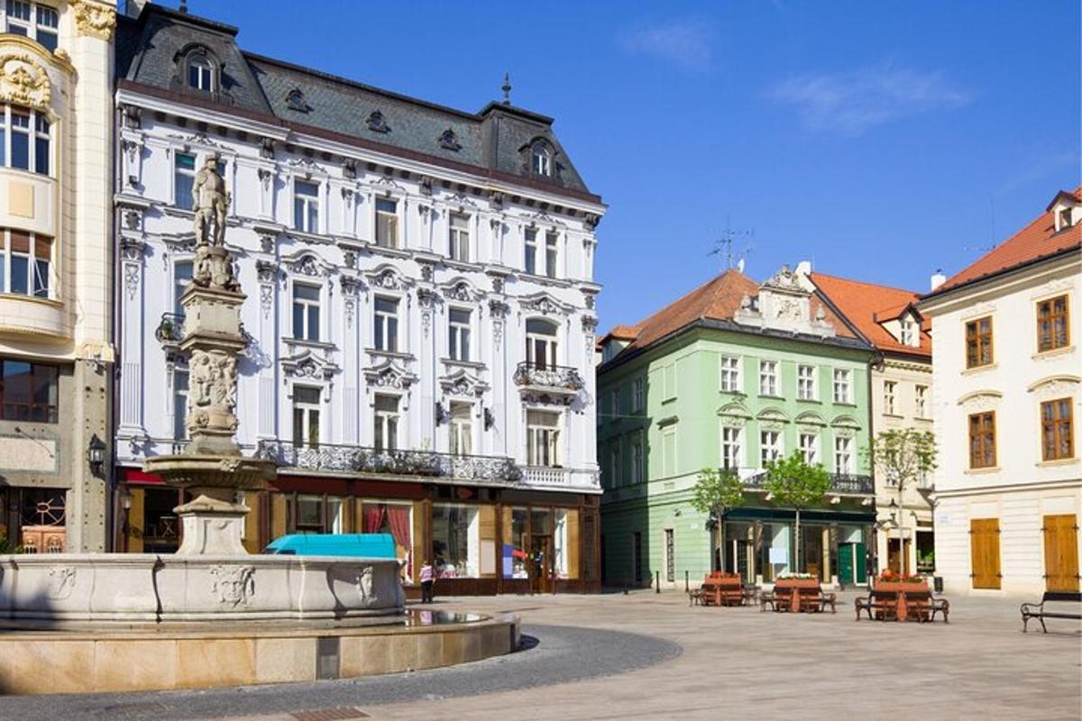 a city square with a fountain in front of buildings