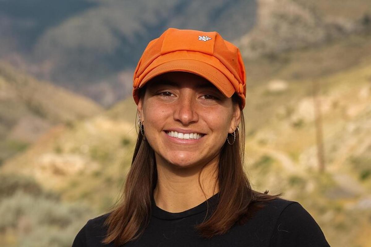a woman wearing an orange hat is smiling