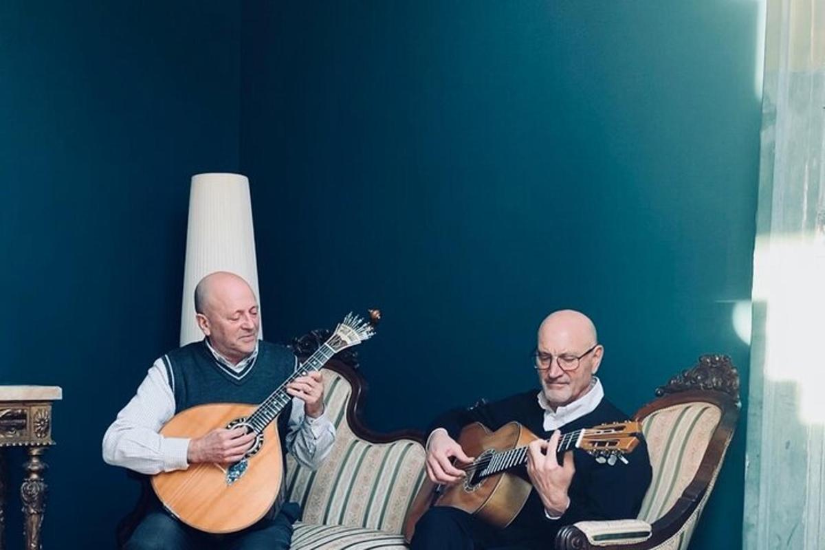 two men are playing guitars in a room