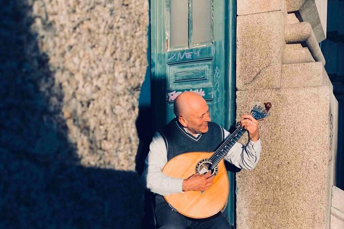 a man playing a guitar in front of a building