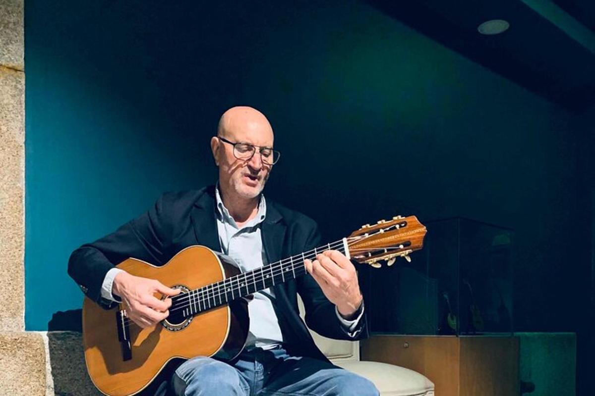 a man sitting on a toilet playing a guitar