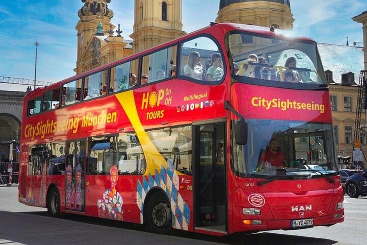 a red double decker bus driving down a street