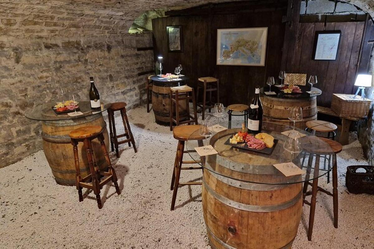 a wine tasting room with barrels and tables with wine bottles
