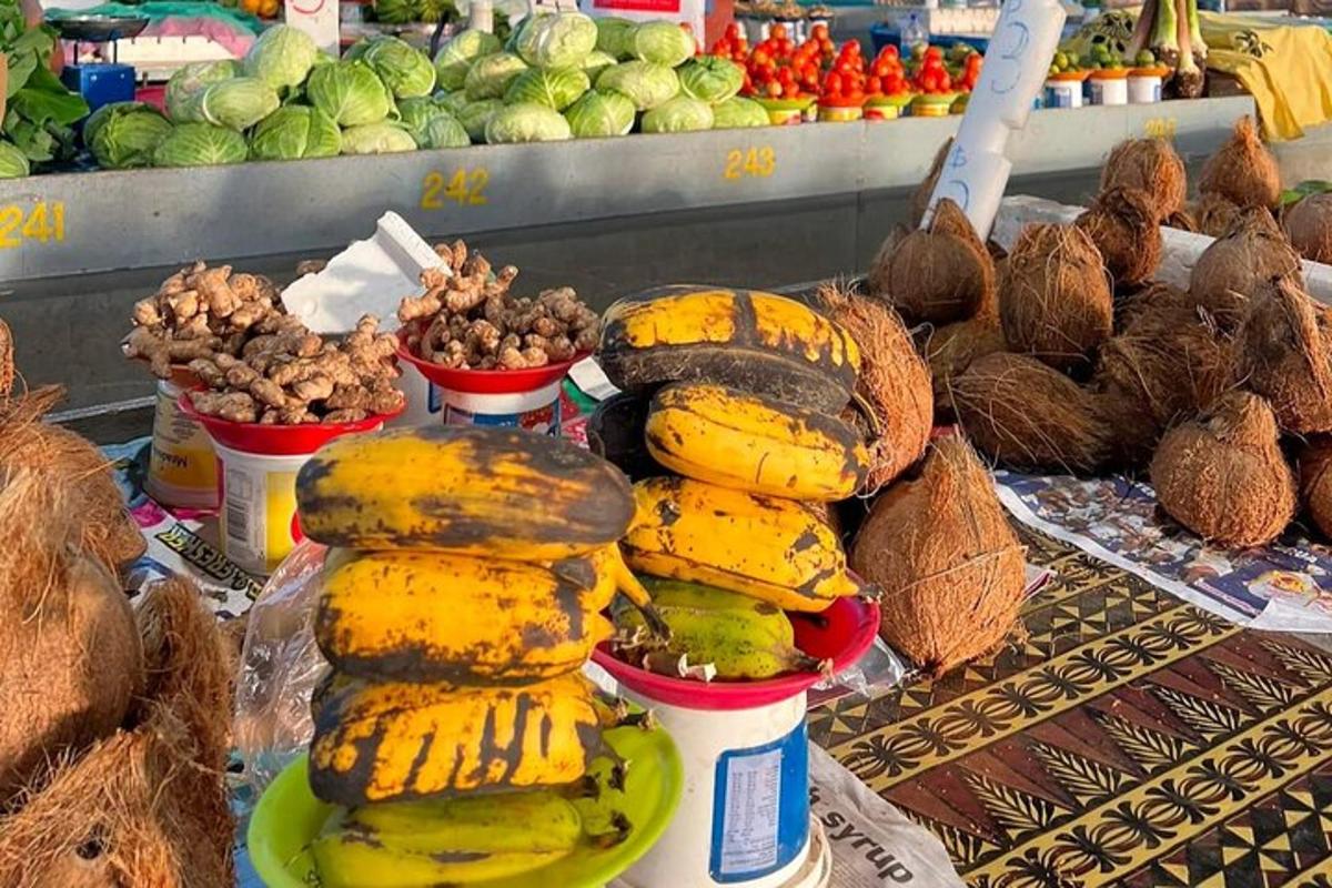 a pile of bananas and other fruits and vegetables on a table