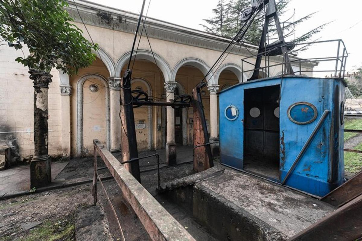 a blue train sitting in front of a building