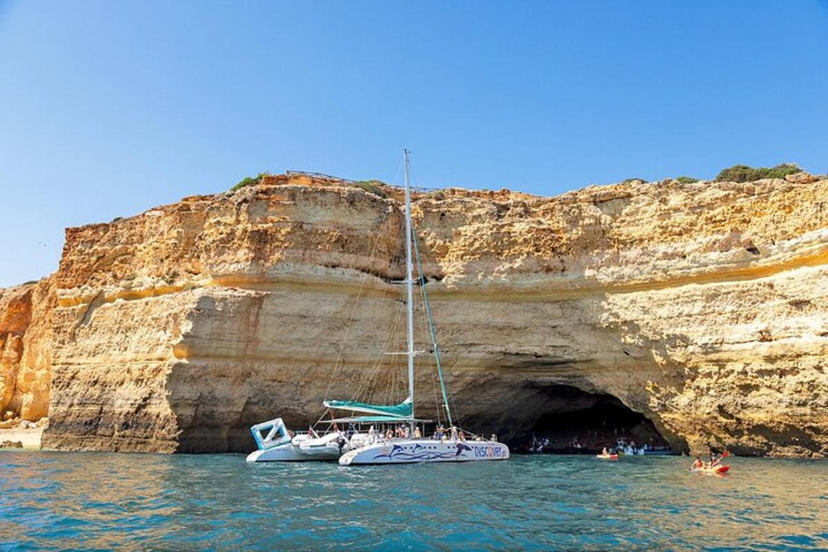 a boat in the water next to a cave