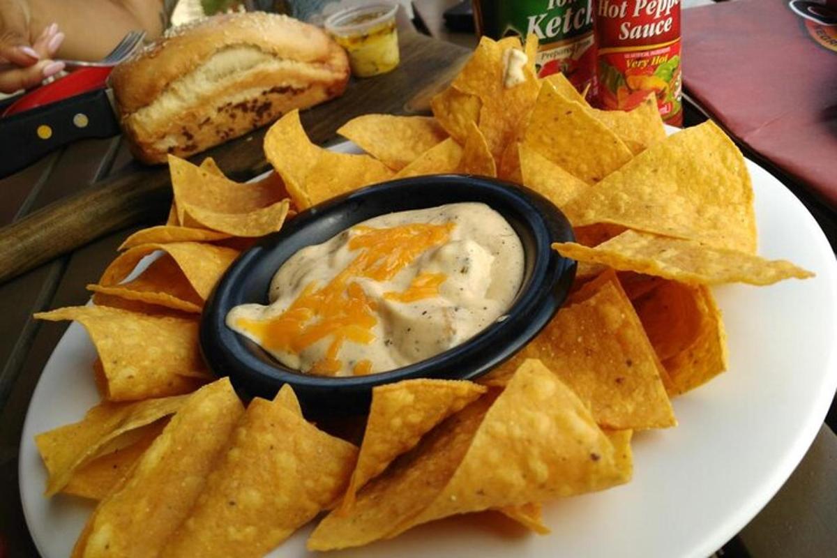 a plate with chips and dip in a bowl