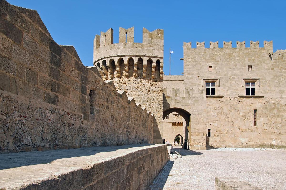 a large castle with a wall and a tower