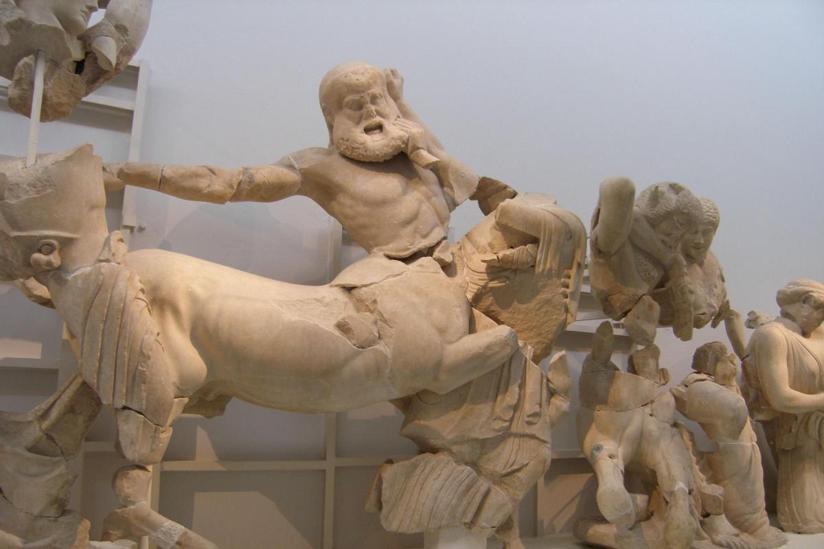a statue of a man riding a horse in a museum