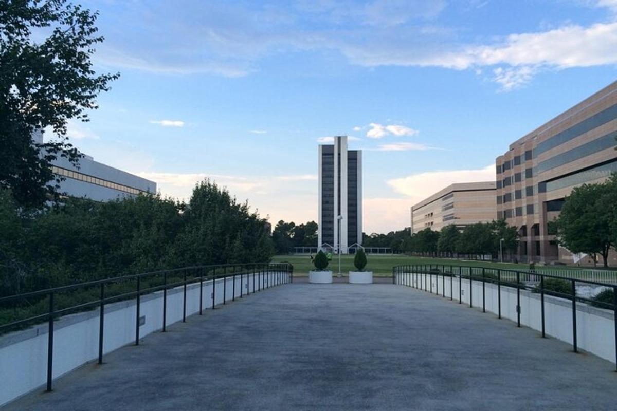 a walkway in front of a building with a fence