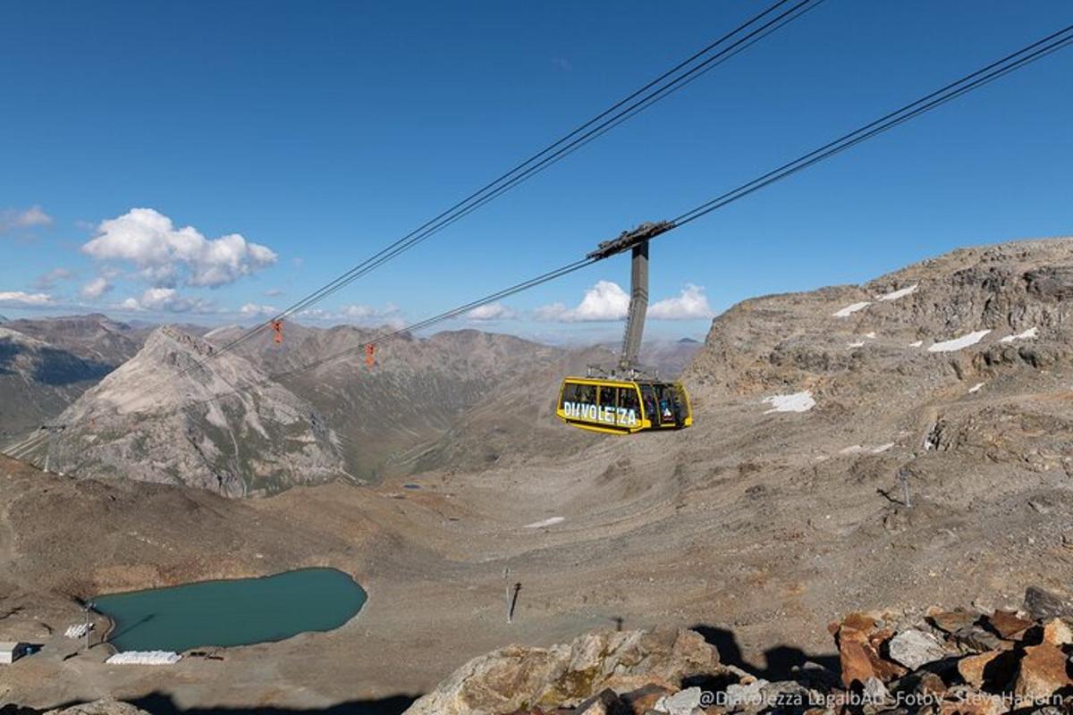 a yellow cable car on top of a mountain