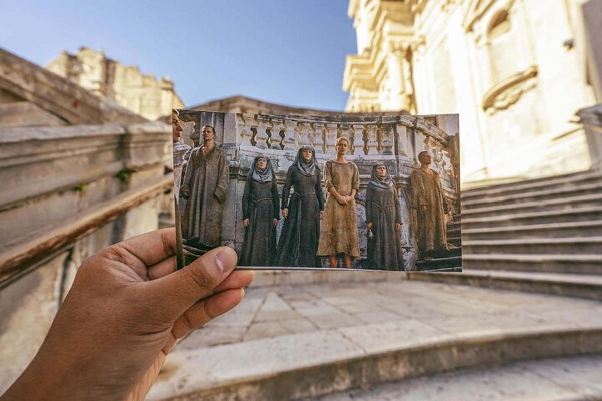 a hand holding a picture of a group of people