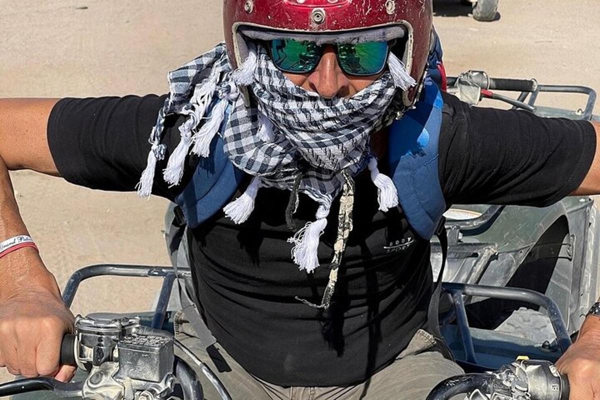 Un hombre que lleva casco y gafas de sol en una motocicleta
