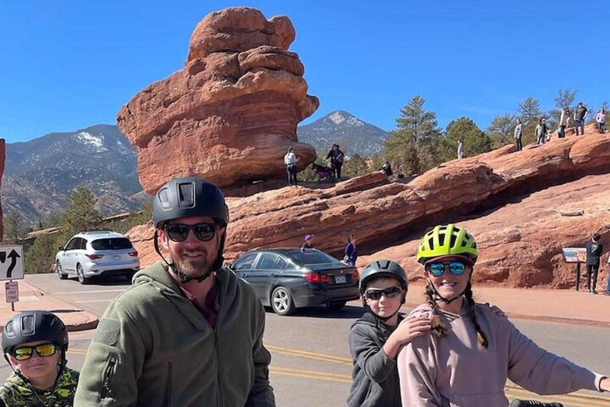 a group of people riding bikes on a road