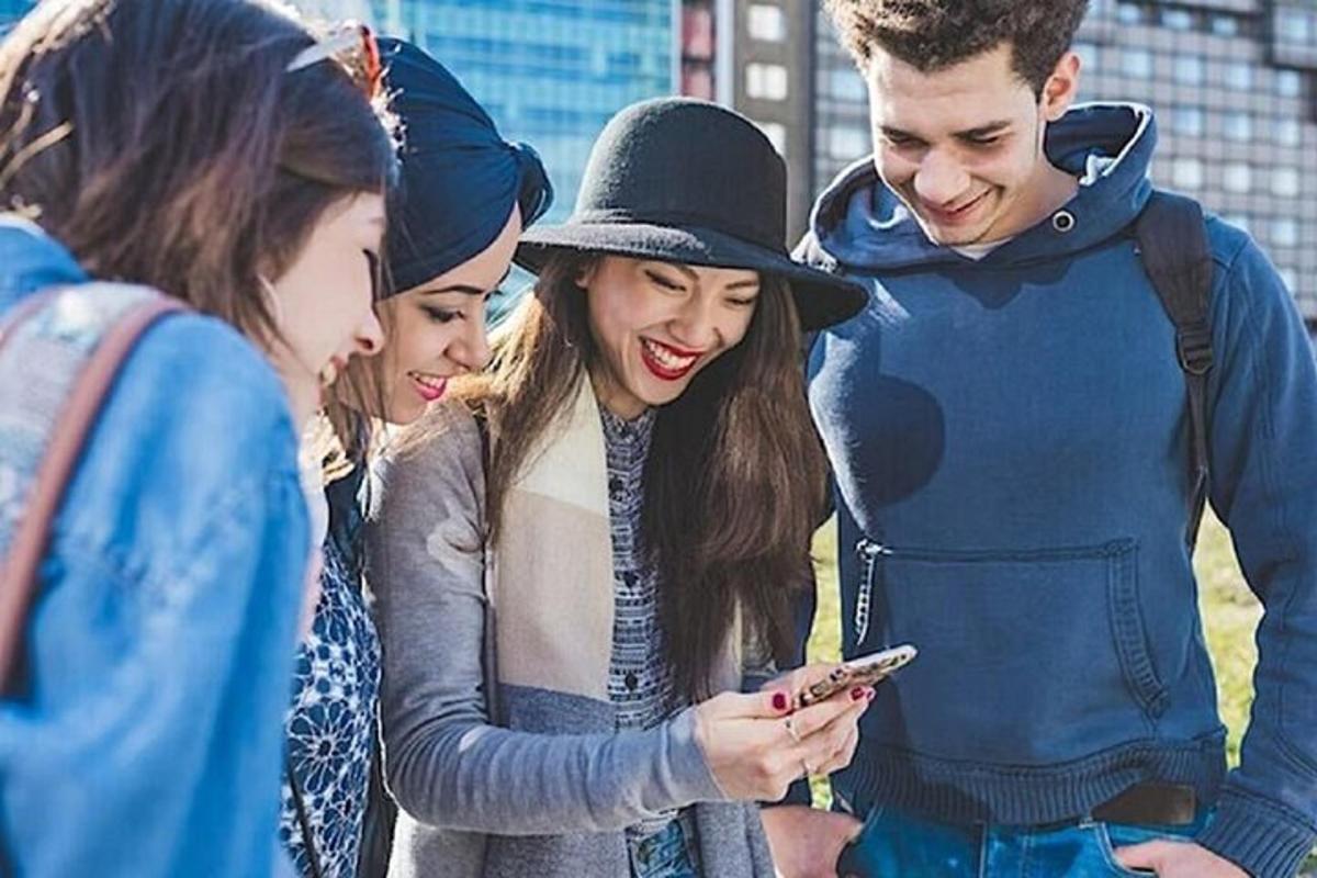 a group of people looking at a cell phone