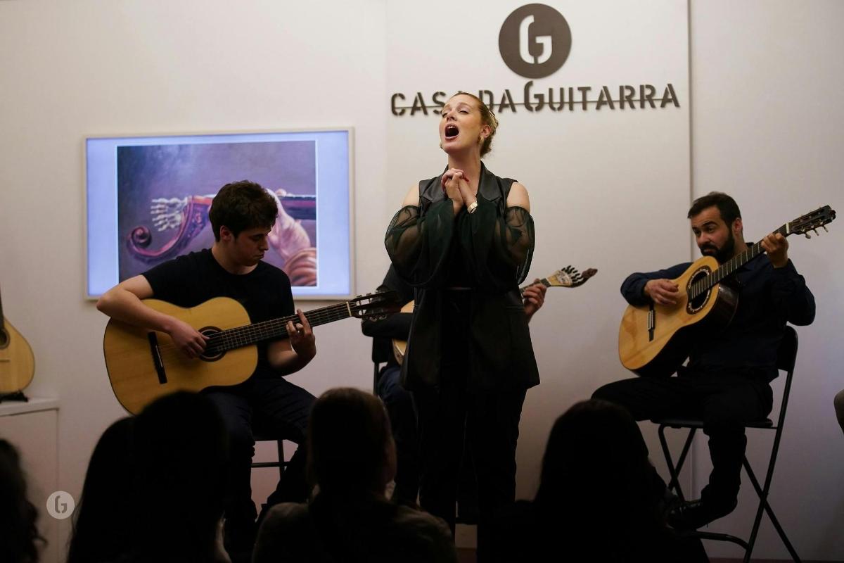 a group of people playing guitars and a woman singing