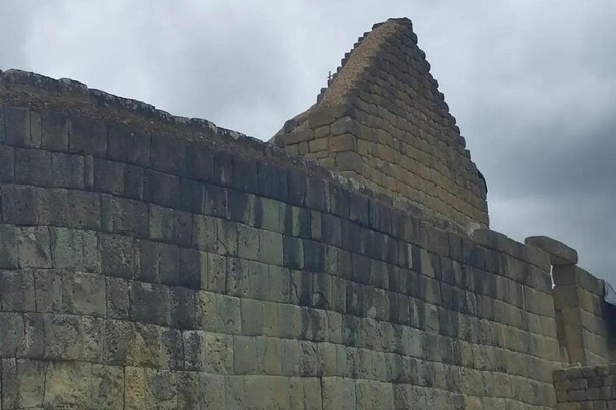 a large brick wall with a pyramid on top