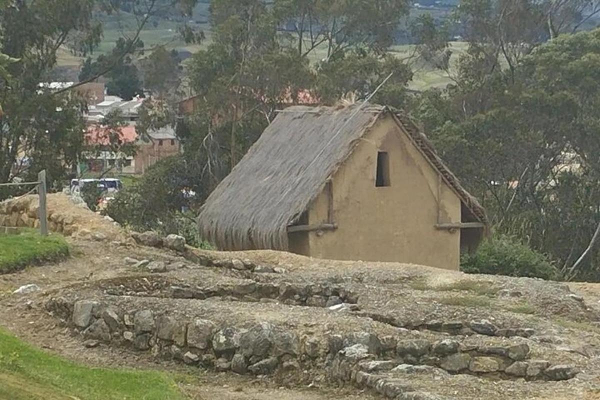 a small building with a roof on a hill