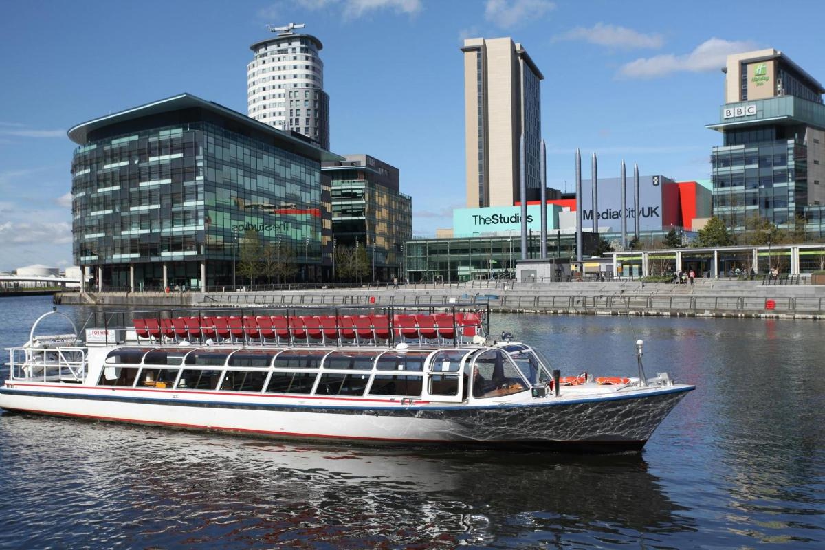 a boat in the water in front of a city