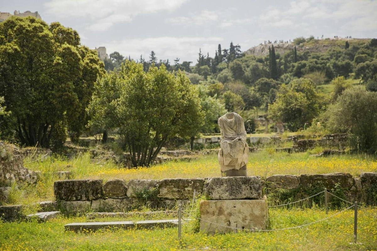una statua di una donna seduta in cima a un campo