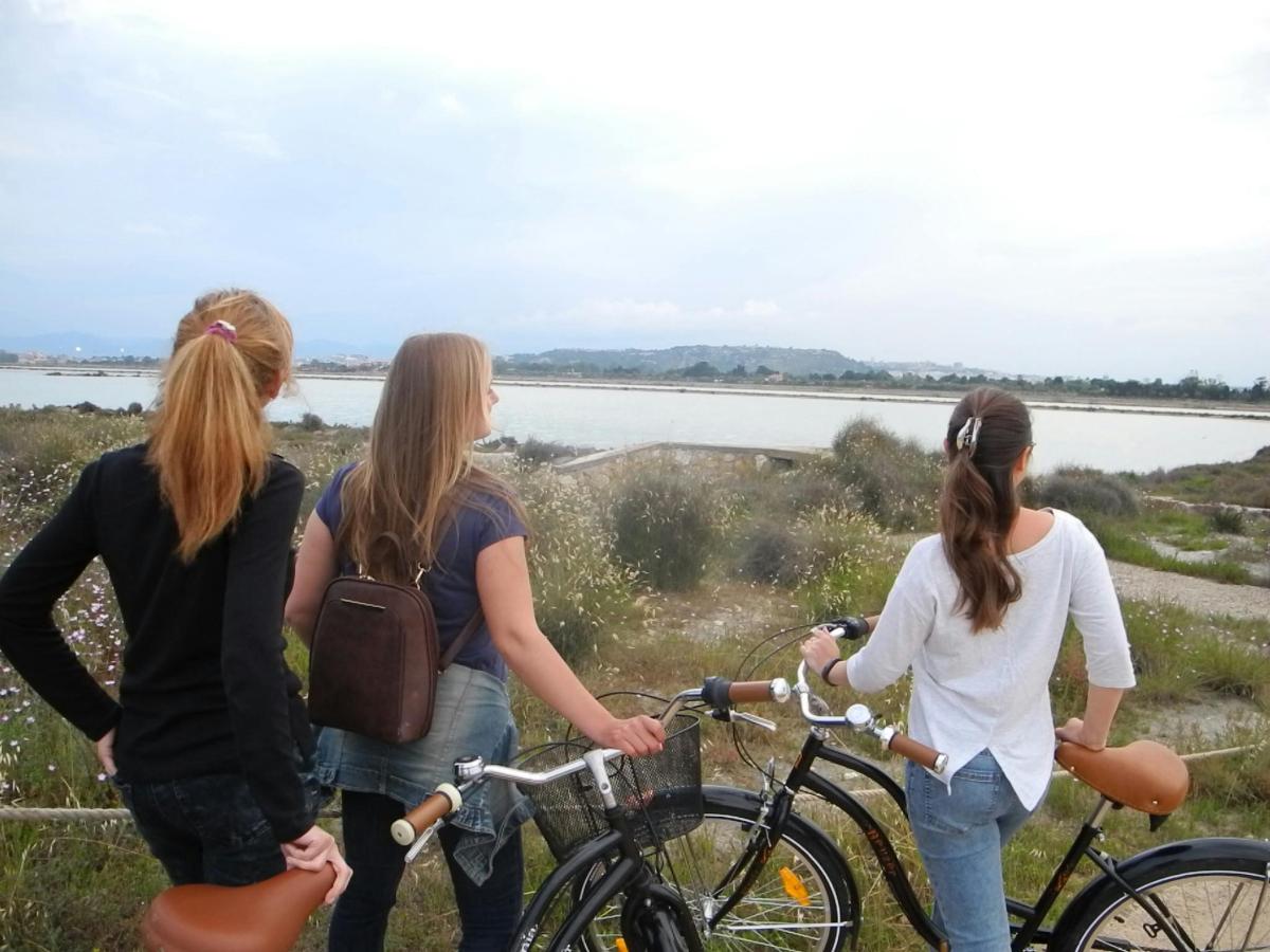 a group of three women standing next to their bikes