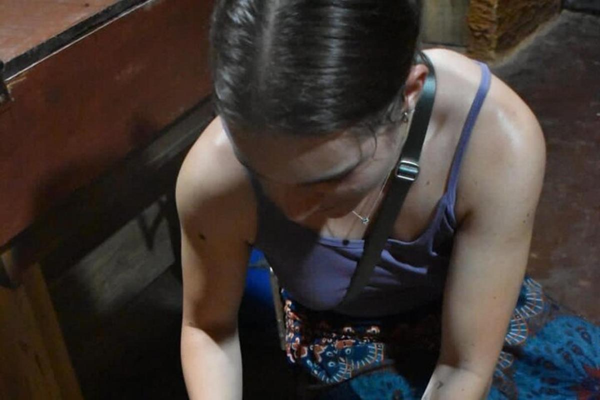 a woman sitting down looking at her cell phone
