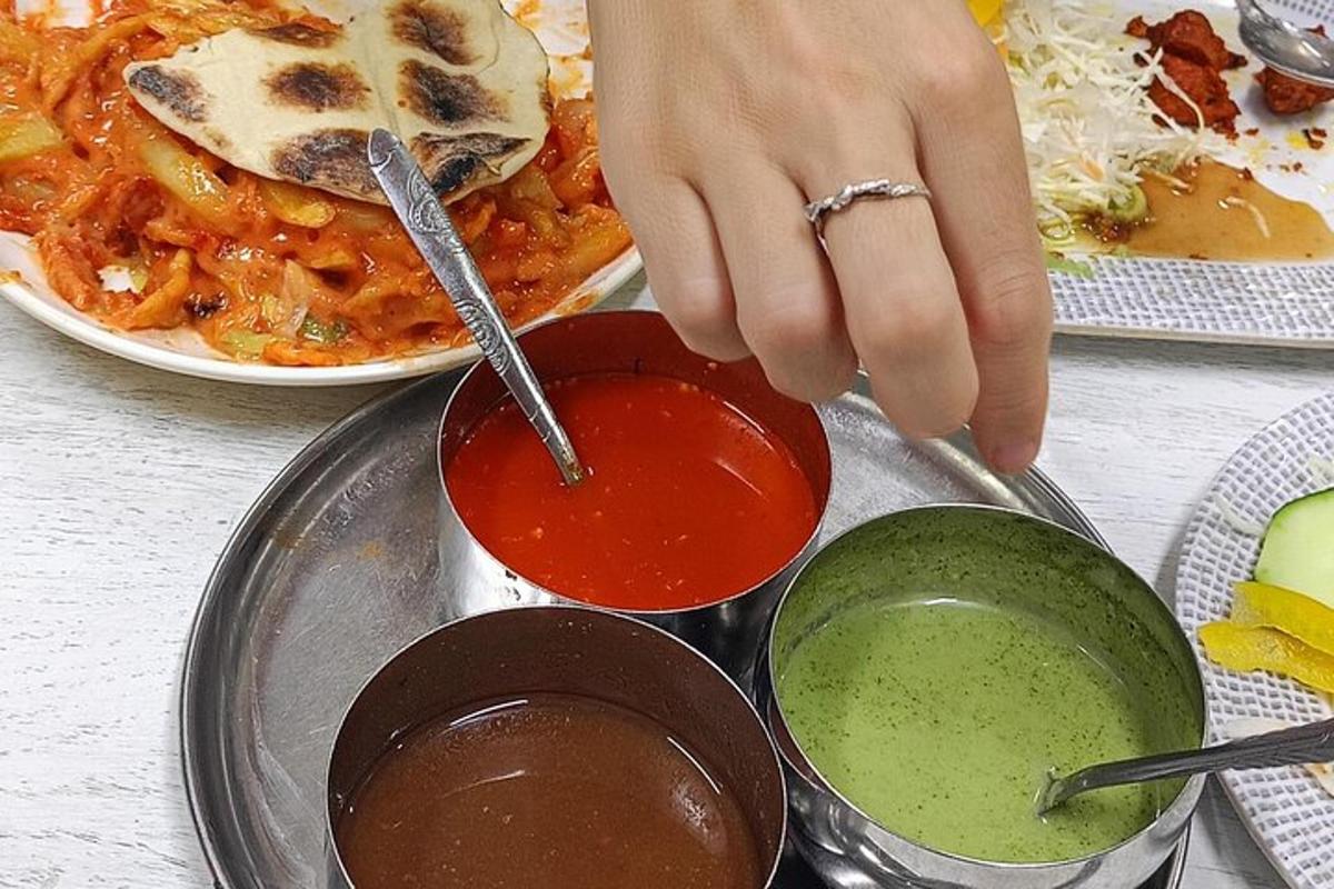 a person stirring sauce in a pot with a spoon