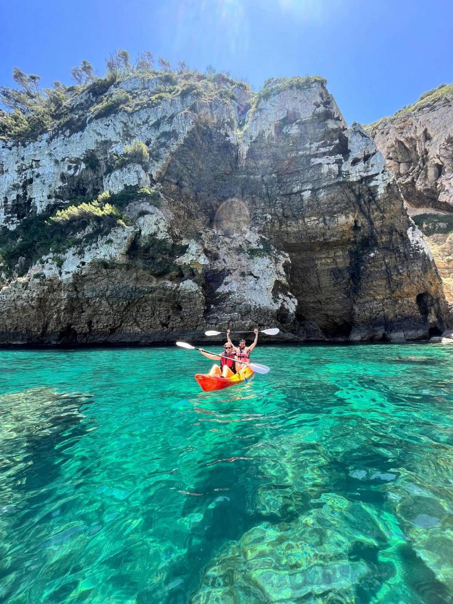 a group of people in a kayak in the ocean