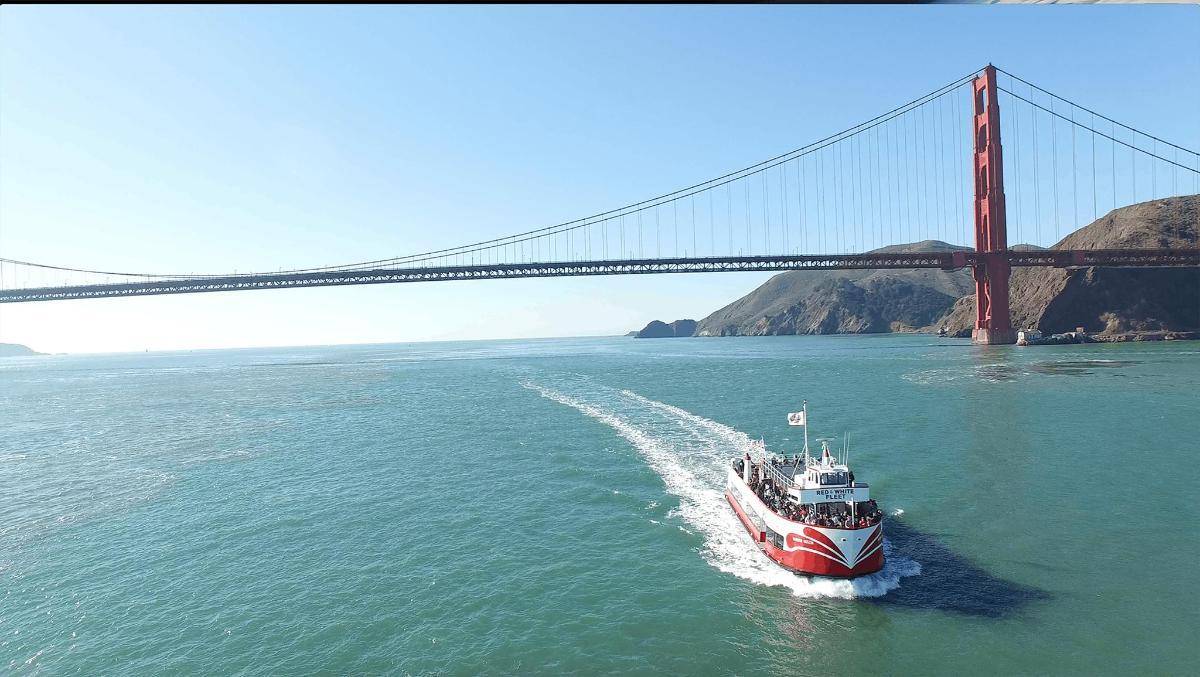 a boat in the water under a bridge