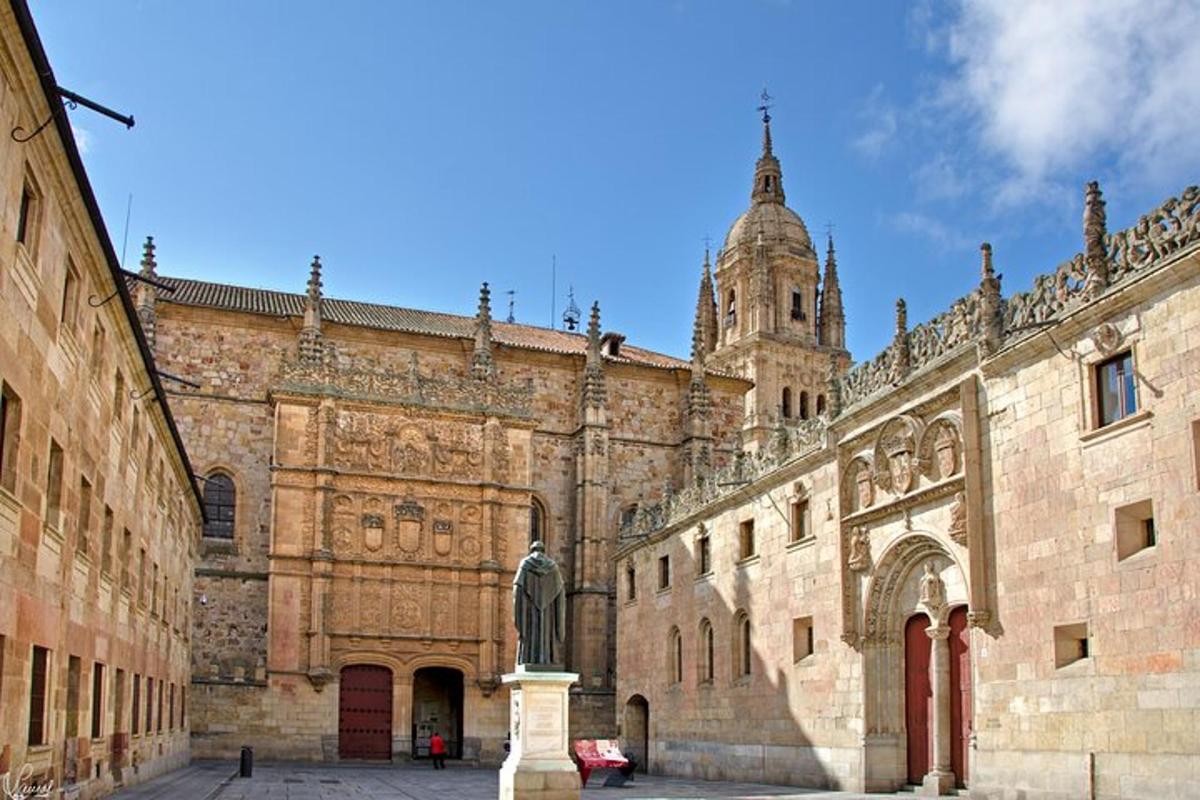 a large stone building with a cathedral in the background
