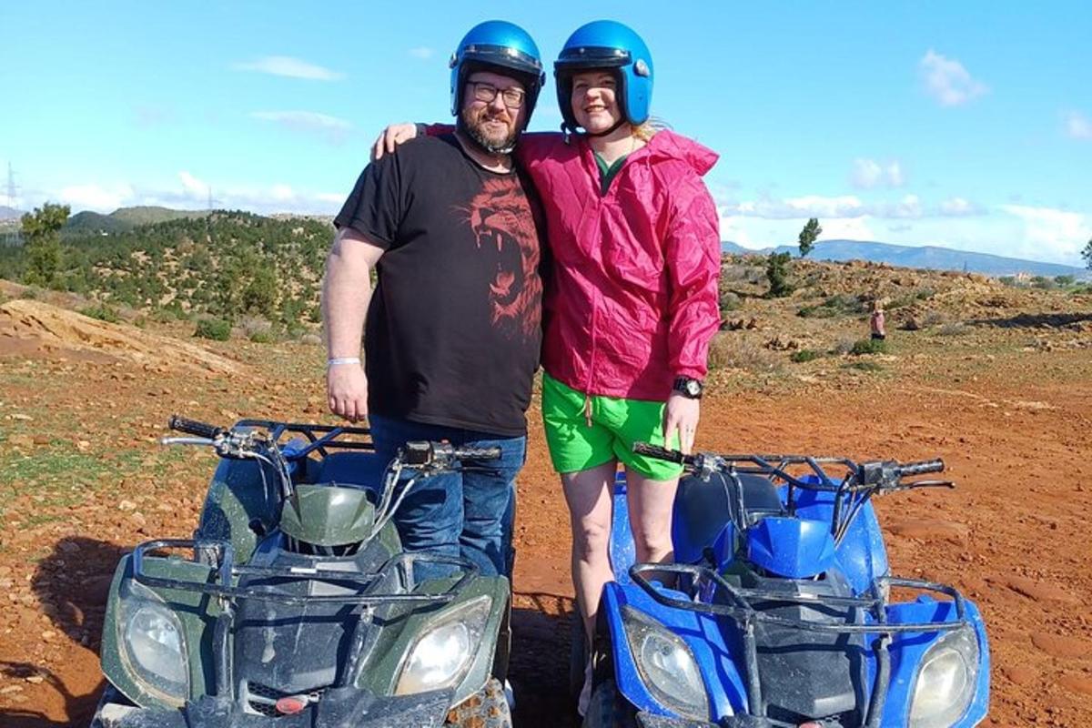 two men are standing next to a motorcycle