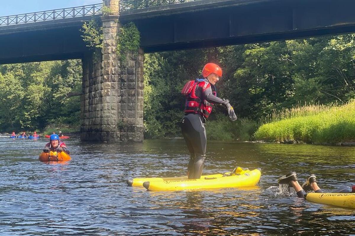 a person standing on a raft in the water