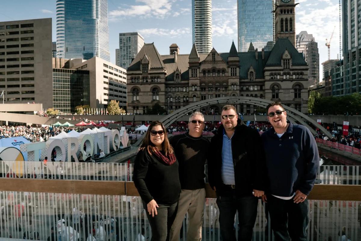 a group of people standing in front of a city