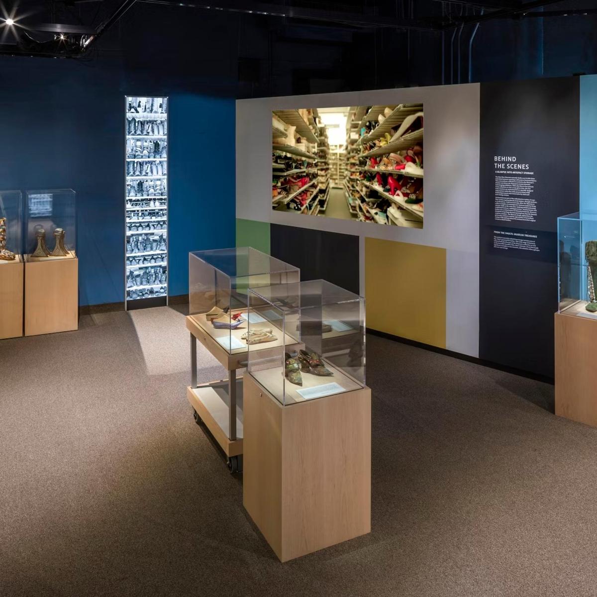 a display case in a museum with shoes on display