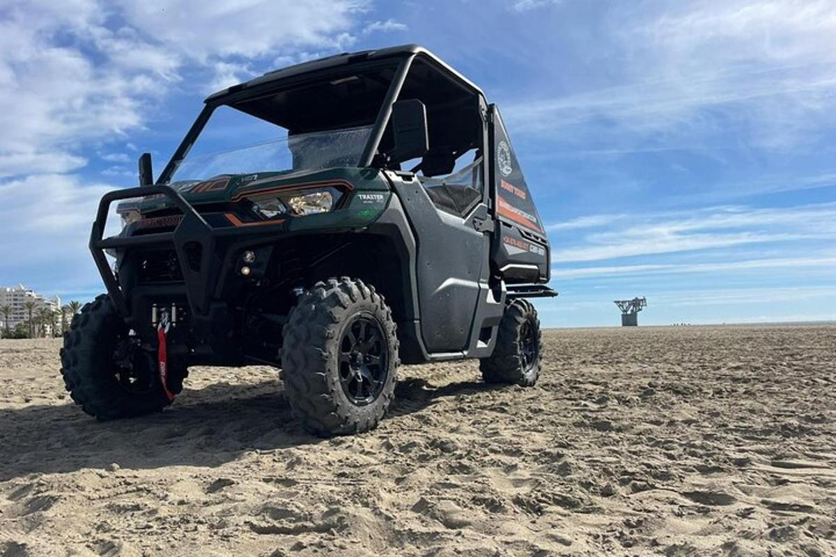 a black atv parked on the sand in the desert