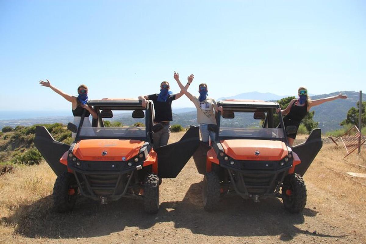 a group of people standing in the back of two atvs