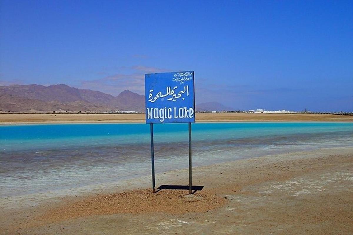 un rètol blau a la vora d'una massa d'aigua