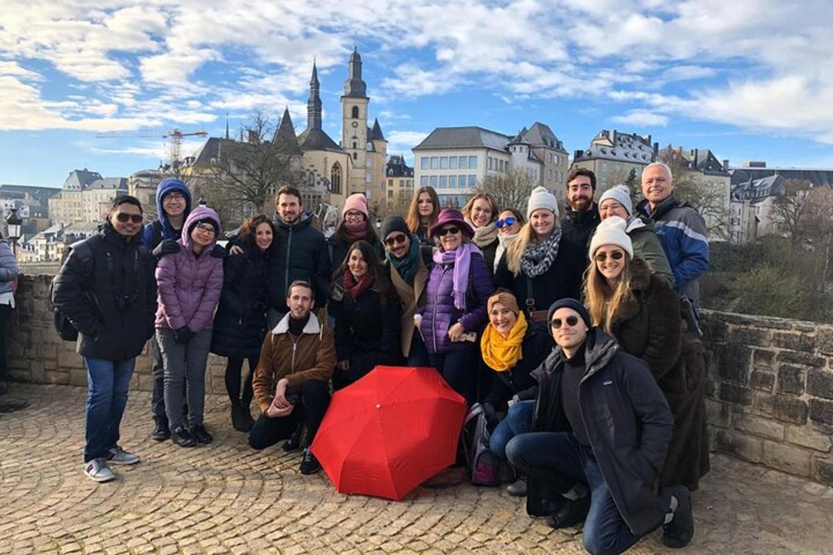 a group of people posing for a picture on a wall
