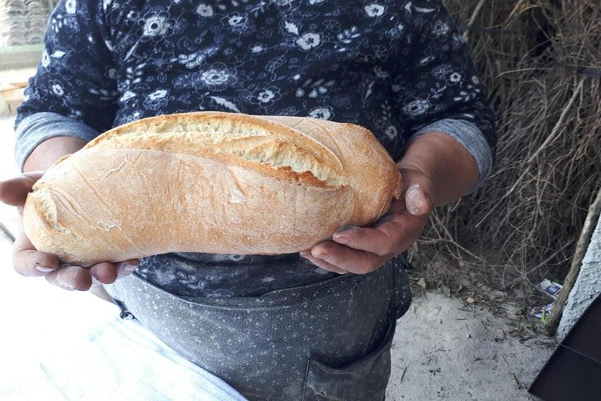 a person holding a large loaf of bread