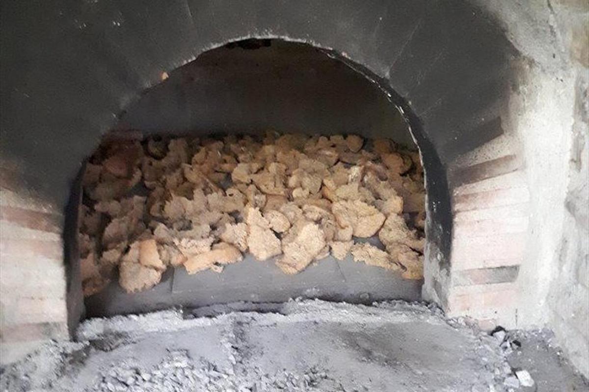 a large pile of food in a brick oven