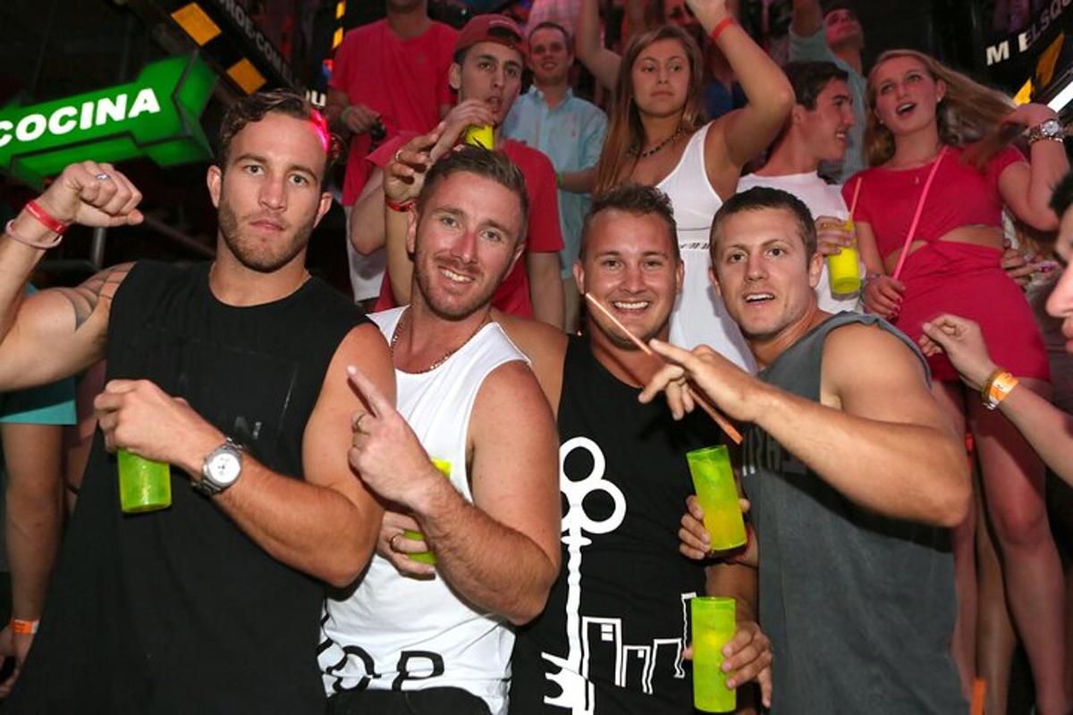 a group of men posing for a picture at a party
