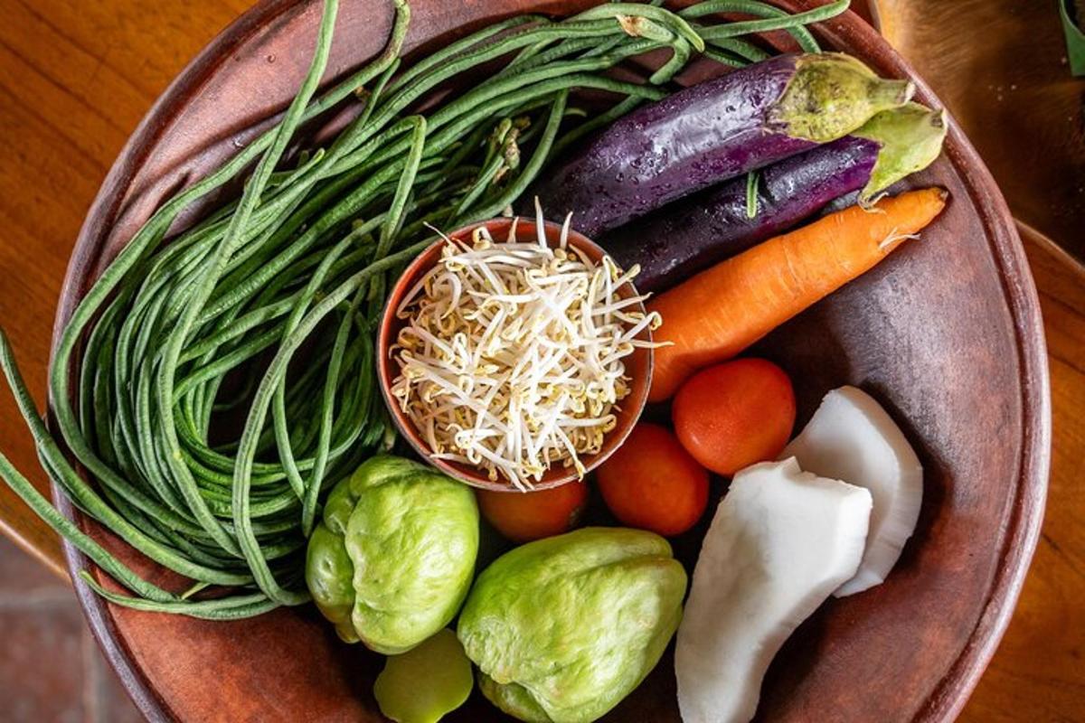 a bowl filled with vegetables on a wooden table