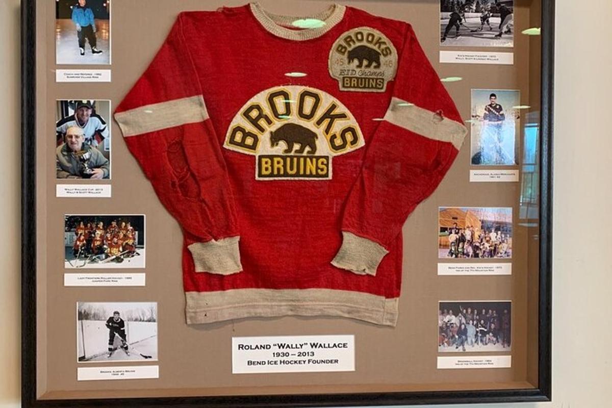 a red sweater hanging on a wall with pictures
