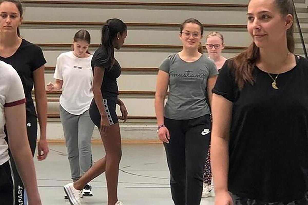 grupa kobiet stojąca na siłowni