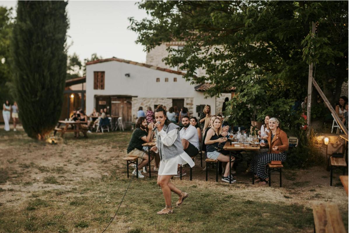 a woman is dancing in front of a group of people